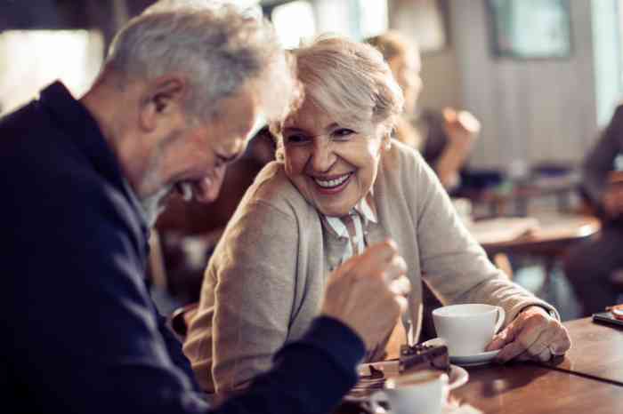 Couple laughing while enjoying a cup of coffee