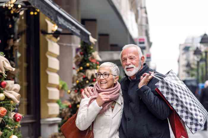 Senior couple holiday shopping outdoors