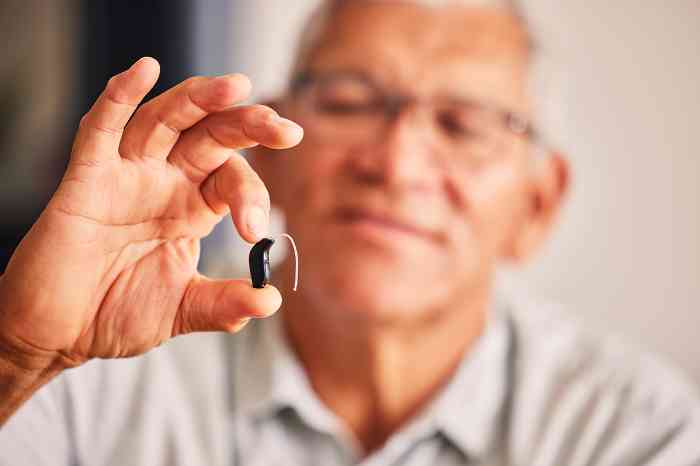 Man showing a BTE hearing aid
